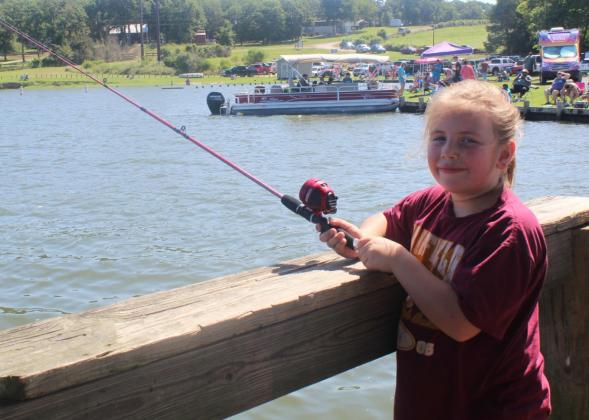 Baylor Watterson is all smiles as she fishes at the Kid Fish Derby at Lake Limestone on Saturday morning. She will be a 3rd grader at Fairfield. Photo by Mitchell Pate