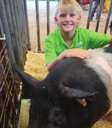 Experienced exhibitor and past showmanship winner Alaina Baker poses with her pig, Cadd, and first-year showman Tripp Petty poses with his pig, Tillie. They are ready for the challenges the show ring can bring at the Freestone County Fair’s swine show next week. Photos by Mitchell Pate/The Fairfield Recorder