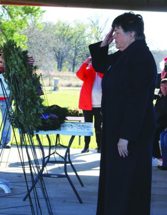 Military veteran and DAR treasurer Beth Harrison salutes after placing a ceremonial wreath at the opening of the National Wreaths Across America Day ceremony at Driver Cemetery this past Saturday. Photo by Mary Cryer Awalt/The Fairfield Recorder