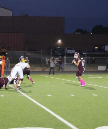 Kaden Crawford (#5) looks for a receiver in the pocket. Photo by Thomas Leffler