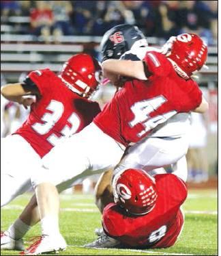 BELOW: Groesbeck defenders, including Garrett Gruell (9) and Hunter Flippin (44) take down a West runner during Friday night’s game. Photos by Angela Crane/ Special to The Groesbeck Journal