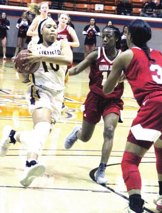 LEFT: Sophomore Breyunna Dowell (#10) takes it to the hole against Hardin-Jefferson, part of a rim-attacking effort by the Lady Eagles.