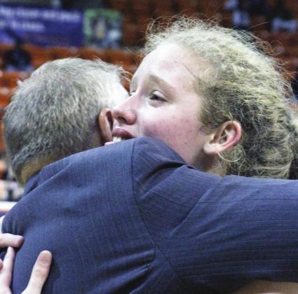 LEFT: Braden Bossier hugs it out with father Scott in the glow of the Lady Eagles’ Regional success.