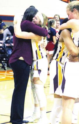 ABOVE: Belle Johnson (#22), one of many veterans on the Lady Eagles roster, embraces coach Sally Whitaker after the Regional final.