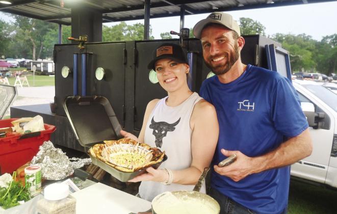 Amy and Brett Nicholas of Dickinson make crab claws with a cheese sauce. Photo by Mitchell Pate/ Fairfield Recorder