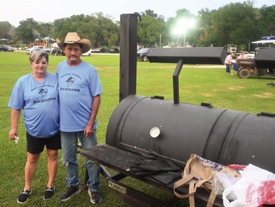 ABOVE LEFT: Ken Rieves of Streeman competes in the Freestone County Go Texan 3rd Annual BBQ Cook Off. ABOVE RIGHT: Blake West makes BBQ Sushi which includes pulled pork, rice, seaweed paper, pickles, cheese, and sauces. BELOW LEFT: Chris Smith and Karmen Holeyfield make a Dutch Oven Peach Cobbler. BELOW RIGHT: Cathy Winstead of Fairfield and Bubba Williamson of Groesbeck make up the Booger County Bandits and compete in the BBQ Cook Off over the weekend. Photos by Mitchell Pate/Fairfield Recorder