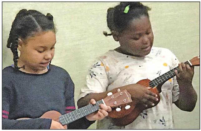 Trinity Star Arts Council students Lyndal Sumuel (left) and Nevaeh Brackens (right) create some grooves on the ukulele, part of a course set up by TSAC and taught by Rachel Bossier. Full story on page seven. Photo by Mary Cryer Awalt