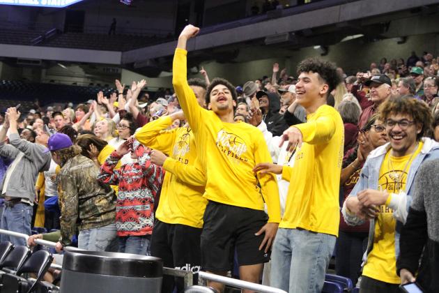 Members of the Eagles basketball squad react to Clark's overtime heroics.
