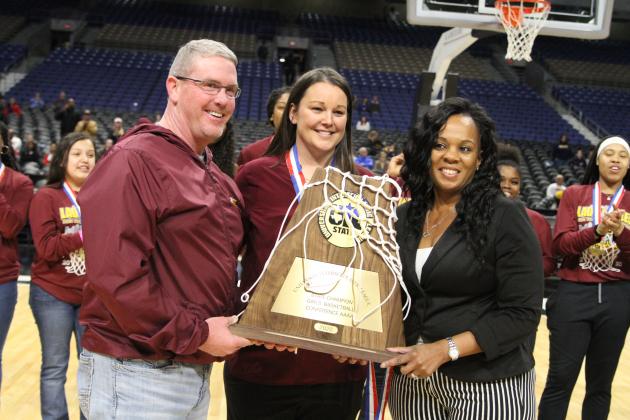 FISD Superintendent Adams, Lady Eagles coach Sally Whitaker and FHS Principal Sonya Gibson hoist the 4A State trophy.