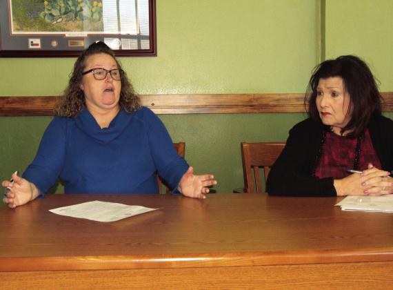 Freestone County Treasurer Jeannie Keeney, left, tells County Commissioners at their Nov. 22 meeting about electronic switches required for Internet service. At right can be seen County Auditor Karen Craddock. Photo by Roxanne Thompson/Fairfield Recorder