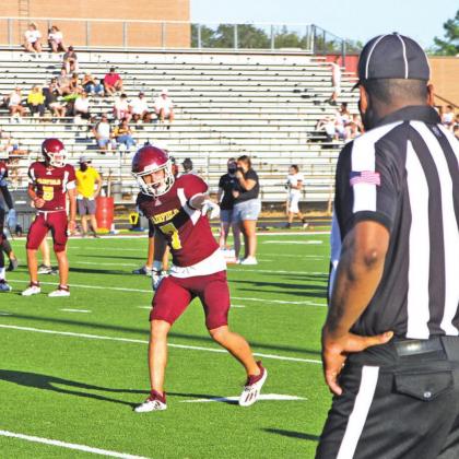 Hunter Noland (#7) checks in with the referee before the wideout takes off. Photo by Thomas Leffler