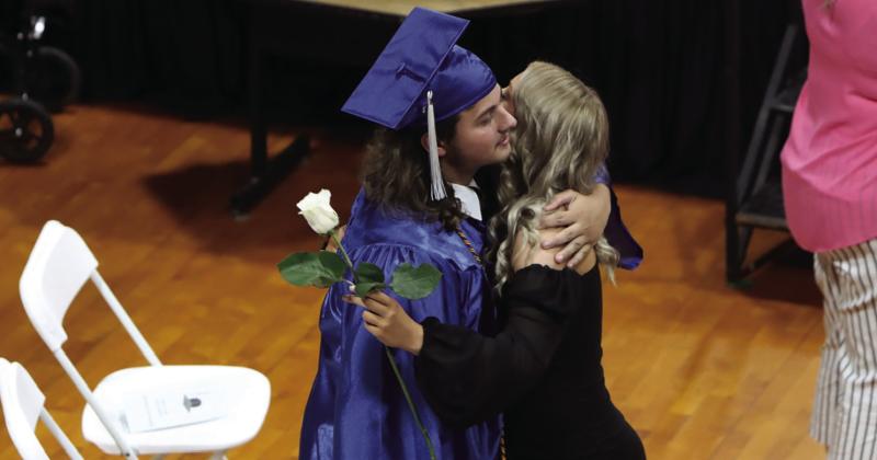 Wortham graduating senior Bobby Preston, left, gives a white rose and a hug during the Class of 2023 commencement ceremony at the Wortham gym Friday night, May 19. Photo by Jennifer Lansford/Fairfield Recorder