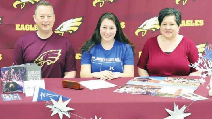 Fairfield High School senior Joy Stachmus signs her letter of intent to attend Oklahoma City University to pursue a Bachelor of Fine Arts in Acting for Stage and Screen. She is pictured with her parents, Jeffrey and Kristy Stachmus.