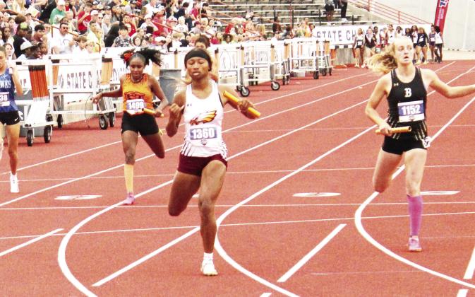 LEFT: Blayke Brackens (left) hands the baton off to Avery Thaler during the 4x200-meter relay last Thursday in Austin. RIGHT: NaKayla Conner (center) crosses the finish line for the Fairfield Lady Eagles during the 4x200. Brackens, Conner, Thaler and Madox Mitchael won the event and set a school record in the process with a time of 1:40.48. Photos by Jason Chlapek/Fairfield Recorder