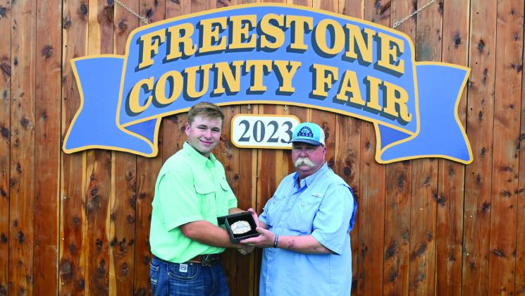 River Bonds of Fairfield FFA won the Kindness from Case belt buckle this year at the 2023 Freestone County Fair. George Robinson presents Bonds with the buckle in memory of his son, Case Robinson. River, who will be a senior at Fairfield High School this fall, is the son of Jerry and Maggie Bonds. Photo by Mitchell Pate/Fairfield Recorder