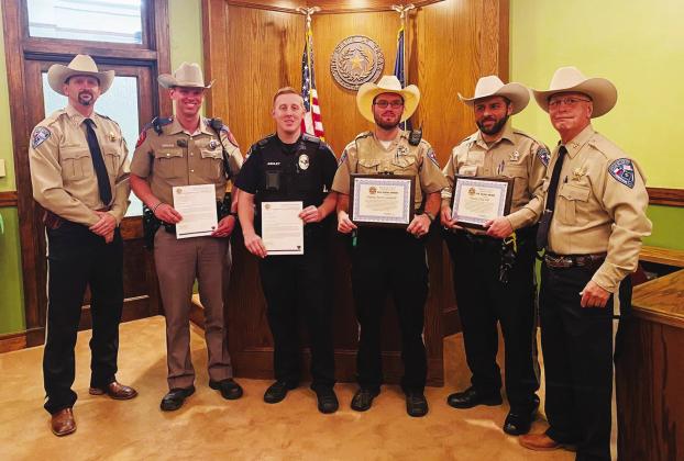 Freestone County Sheriff Jeremy Shipley (left) and Chief Deputy Devin Mowrey (right) honor DPS Trooper Josh Schlaudt, Fairfield Police Department Officer Josh Ashley, FCSO Deputy Justin Campbell, and FCSO Deputy Chad Hill for their courage and bravery in saving the lives of two young adults following a crash in the early morning hours of Oct. 8. Contributed photo