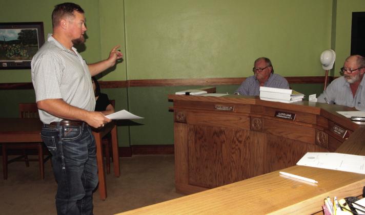 Brian Stallones, vice president of ANCO Insurance, at left, explains to Freestone County Commissioners how the emergency medical transport add-on works at the Aug. 21 Commissioners Court meeting. At right can be seen Precinct 4 Commissioner Clyde Ridge Jr. and Precinct 3 Commissioner Lloyd Lane. Photo by Roxanne Thompson/Fairfield Recorder