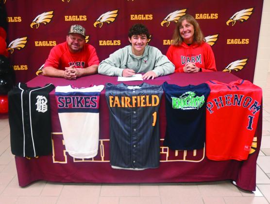 Rowdy Hand signs his letter of intent to play baseball at the University of Arkansas Rich Mountain as his parents Ty and Kerry Hand are all smiles on Friday morning, March 22. Courtesy Photo