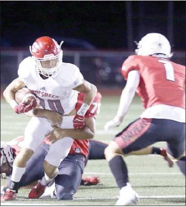LEFT: Groesbeck’s Beau Pagel tries to escape a tackle during the Goats’ 47-0 disstrict-opening loss to Maypearl. Photo by Skip Leon/ The Mexia News