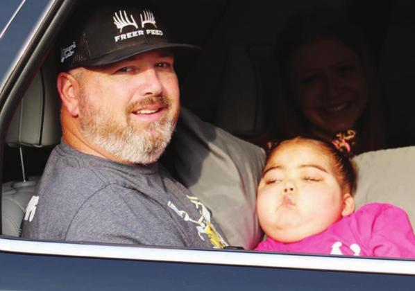 Fairfield’s Aubree Henderson, a 5-year-old brain tumor victim, is held by her Grandpa Jay Pierce, as she served as one of the two Grand Marshals of the “Brain Tumor Awareness Parade” around Fairfield Elementary School Tuesday, May 17. Her grandmother, Dana Pierce, was driving the vehicle. Aubree’s mother, Peyton Pierce, is in the car, too. Photos by Curtis Burton/Fairfield Recorder