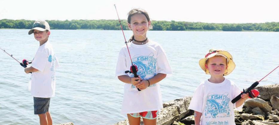 BELOW: Siblings Liam, Bailey, and Landon Ryan of Teague enjoy fishing together during the 20th Annual Kid Fish Derby. Photos by Mitchell Pate/ Fairfield Recorder