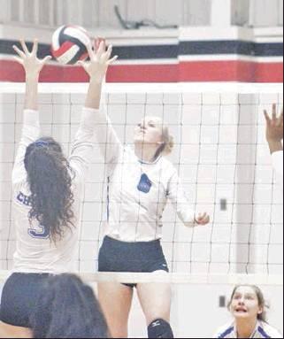 Wortham’s Skylar Phillips (6) tips the ball over the outstretched hands of a Chilton blocker during a bi-district volleyball match in Axtell on Monday. Photo by Skip Leon/The Mexia News