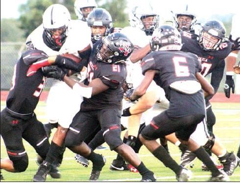 A host of Mexia tacklers team up to stop Malakoff running back Keevie Rose in the first quarter of a game at Blackcat Field on Friday night. Making the stop are Isaak Sandoval (left), Dre’vaun Cooper (21) and Jalil Wright (6). Looking help out are Jacob Allen (20) and Arik Medlock (70). Photo by Skip Leon/The Mexia News