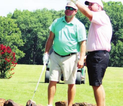 Jeff Hughes, left, and Taylor Paul discuss strategy on the No. 1 tee box during the Dog Fight golf tournament Sunday, July 19. The Fairfield men won the tournament. Photo by Richard Nelson/The Mexia News