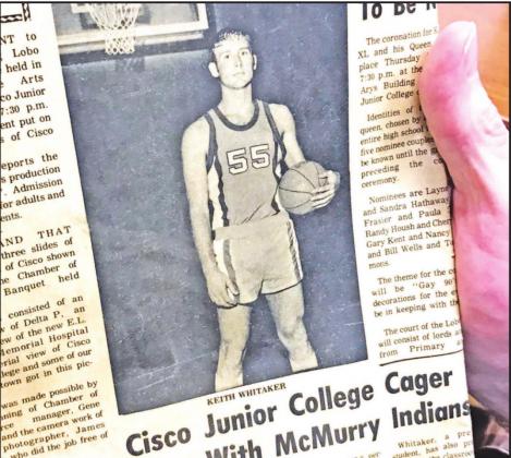 FHS Assistant Principal Keith Whitaker shows off a blast from the past, a newspaper clipping on his basketball background. Photo by Mary Cryer Awalt