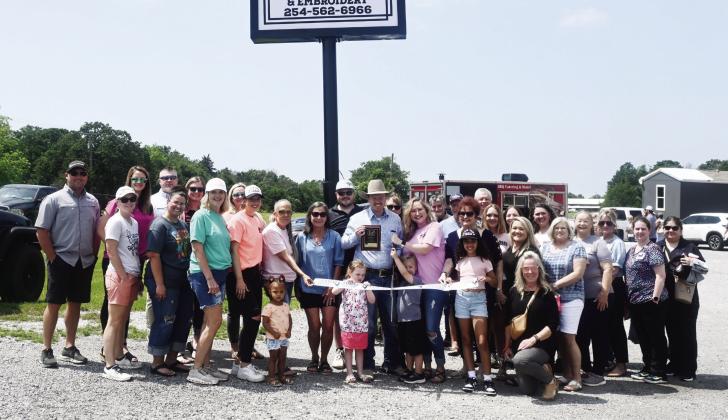 Family, friends, and community members gather on April 30 for the Grand Opening of Small Town Tees in Fairfield. Photo by Mitchell Pate/Fairfield Recorder