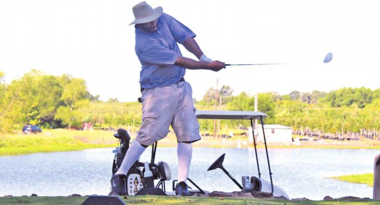 Tony Brackens Jr. (above) focuses and takes a nice swing during the Teague Quarterback Club Golf Tournament. Photo by Mitchell Pate