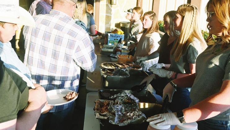 Fairfield 4-H kids serve a BBQ meal to those who attended the 4-H fundraising banquet on Saturday night at The Depot X. Photo by Mitchell Pate/Fairfield Recorder