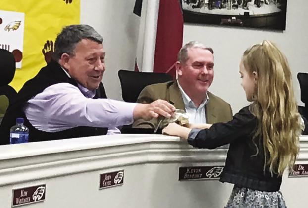 Fairfield Intermediate Student Abby Snider presents FISD Board President Kevin Benedict with a thank-you gift at Monday night’s board meeting. Photo by Mary Cryer Awalt/Fairfield Recorder