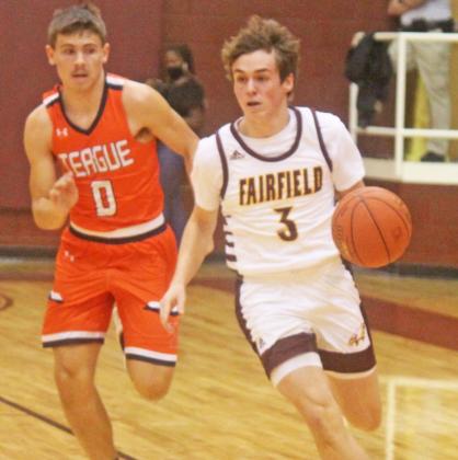 Sophomore Caleb George takes the ball down the court for the Eagles. Photo by Mitchell Pate