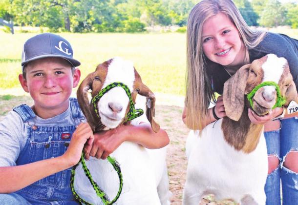 Dawson and Ellie Grissett are ready to show their goats, Cletus and Haggard, at the 2020 Freestone County Fair this month. Photo by Mitchell Pate