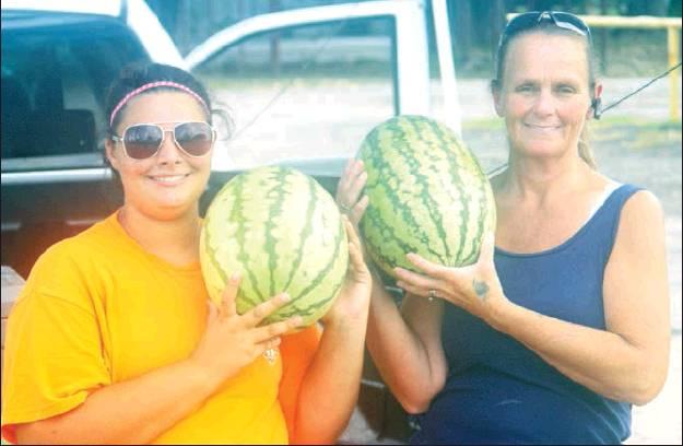 Star, left, and Donna Foster provide watermelons for hungry customers outside of Bobby Jo’s Donut Palace, providing a taste of summer in Fairfield. Photo by Thomas Leffler/The Fairfield Recorder