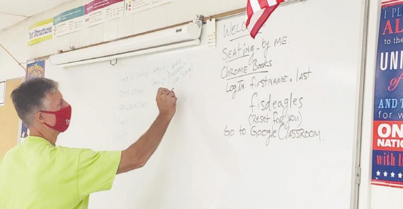 Fairfield Junior High 8th grade English teacher and coach Steve Patt readies his whiteboard for the first day of school. Photo by Mary Cryer Awalt