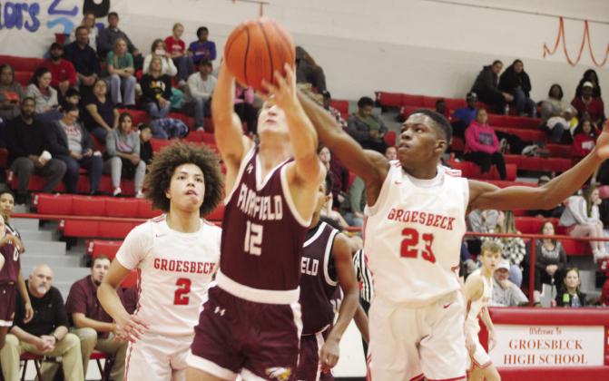 LEFT: Fairfield’s Manny Brown gets control of the ball during a game at Groesbeck on Friday, Dec. 15. Brown hit four three-pointers and scored 14 points to help the Eagles to a 64-33 district-opening victory over the Goats. RIGHT: Fairfield’s Jerry Draper (12) snags a rebound in front of Groesbeck’s Jordan Hutchison (23) during a game at Groesbeck on Friday, Dec. 15. Photos by Skip Leon/Fairfield Recorder