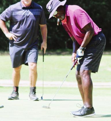 Beasley Reece sinks a putt during a golf tournament at Tri-County Golf Club at the Vineyards between Teague and Fairfield on Sunday morning. Reece, a former NFL player, is a member of the club and golfs there regularly when he’s in the area. Photo by Skip Leon/The Mexia News