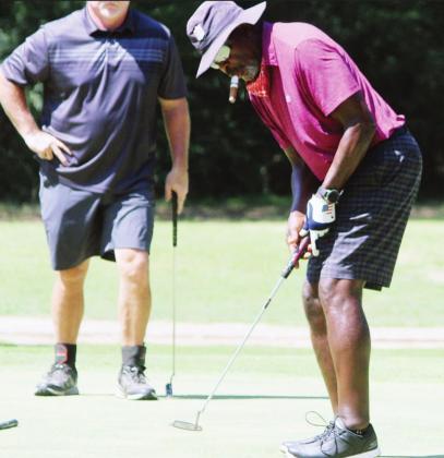 Beasley Reece sinks a putt during a golf tournament at Tri-County Golf Club at the Vineyards between Teague and Fairfield on Sunday morning. Reece, a former NFL player, is a member of the club and golfs there regularly when he’s in the area. Photo by Skip Leon/The Mexia News