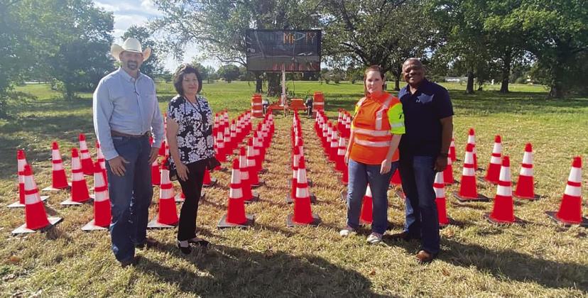 Freestone County Sheriff Jeremy Shipley, Freestone County Auditor Karen Craddock, and two TXDOT representatives are pictured with 109 cones in remembrance of the 109 people lost just in the Bryan District. Thirteen of those lives were lost in Freestone County. Contributed Photo