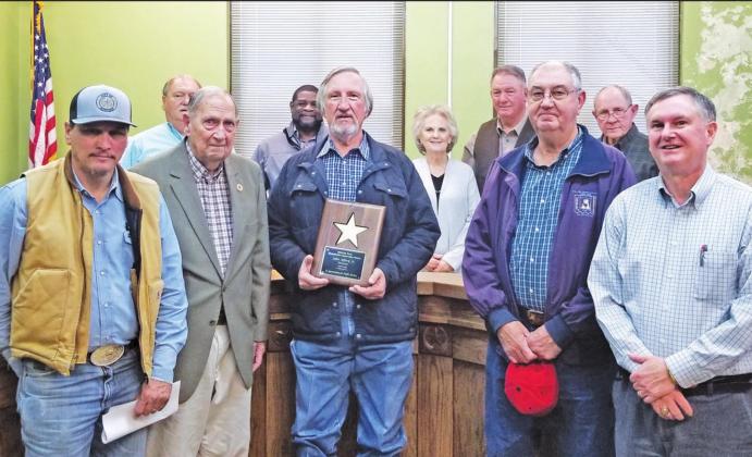 Mid-East Texas Groundwater Conservation District John Alford, Jr. (center) receives a plaque from his organizational teammates recognizing his 19 years of service to the District.