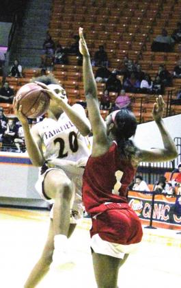 LEFT: Shadasia Brackens (#20) attacks the hoop against Hardin-Jefferson, part of a Lady Eagles’ concerted effort to draw fouls.