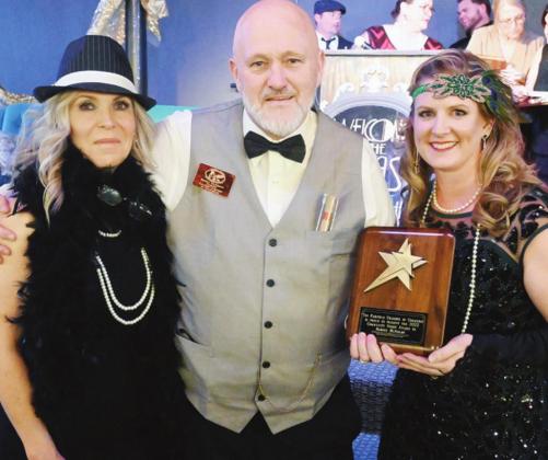 Robert McAdams is presented with the Community Spirit award by Brenda Pate and Asley DeVillier.