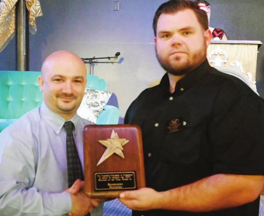 Brookshire Brothers was named Business of the Year. Store Director Jason Walthall accepts the plaque from Eli Pratt.