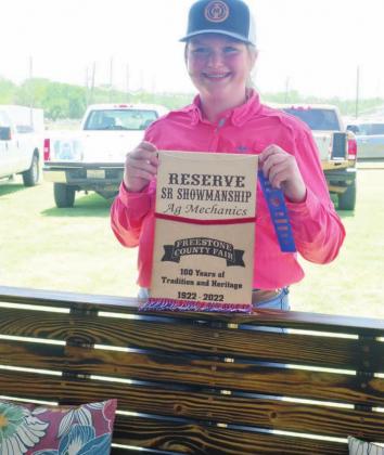 Rainy Bonds of Fairfield 4-H earns the Reserve Champion Showmanship banner for her Ag Mechanics project, a treated pine swing.