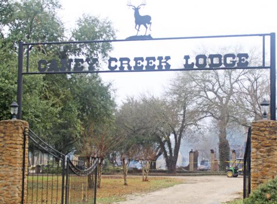 The gate entrance to Caney Creek Lodge remains standing tall, but the lodge itself was a complete loss in a five-alarm structure fire on Saturday night, January 23. Photo by Mitchell Pate