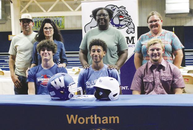 Seated, from left: Wortham athletes Ryken Lewis, Derek Bullard and Tanner Bean each committed to play in college Monday afternoon. Lewis will play baseball at North Lake College in Irving; Bullard will play football at Tabor College in Hillsboro, Kansas; and Bean will play football at Navarro College in Corsicana. Photo by Jason Chlapek/Fairfield Recorder