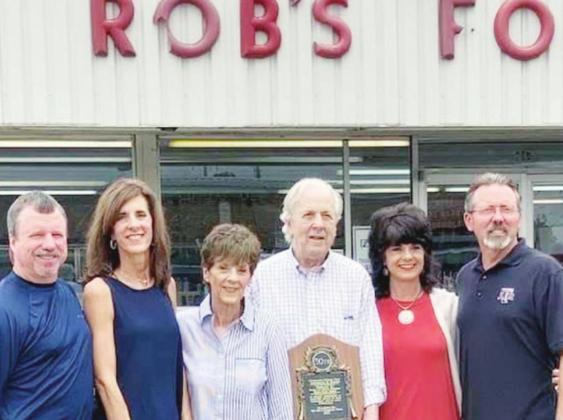 Friends and family were on hand to celebrate the Robertsons’ retirement. Pictured are, l-r, son-in-law and daughter Chris and Debbie Bartlett; store owners Carolyn and Danny Robertson; and daughter and son-in-law Dana and Darrell Brown. Danny is holding a congratulatory plaque from the City of Fairfield.