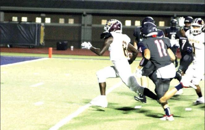 LEFT: Fairfield quarterback Justin Abram runs for some of his 192 yards rushing against Madisonville on Friday night. Abram scored three touchdowns to help the Eagles to a 31-15 victory.